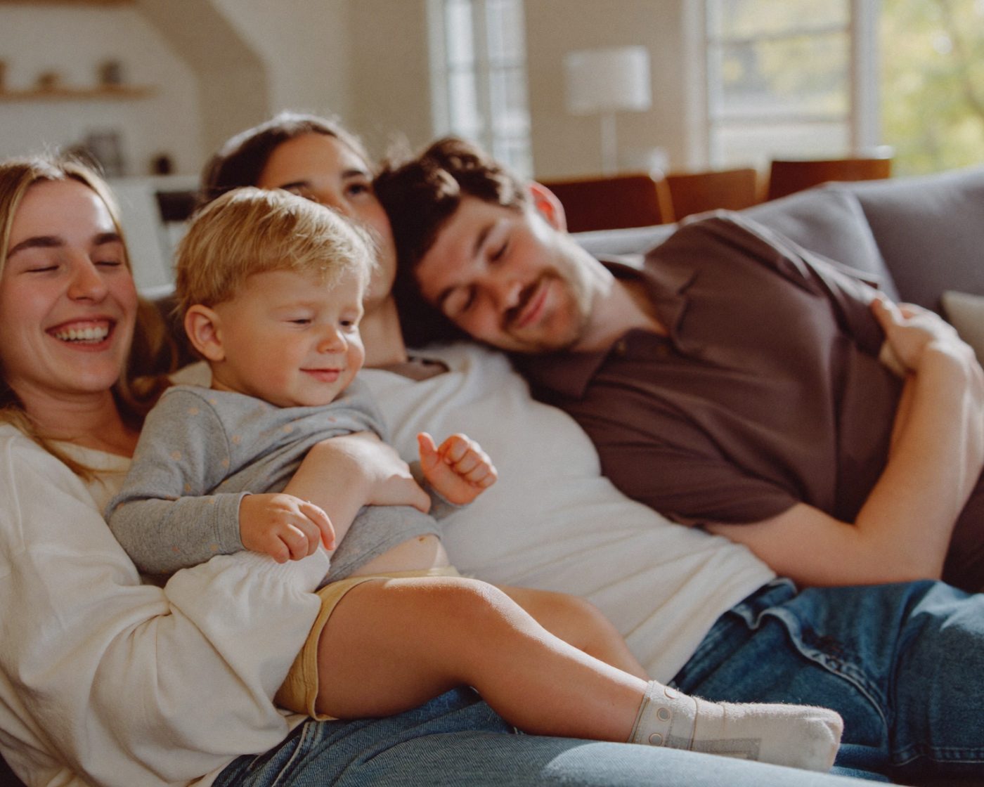 A family relaxing in the living room of their home